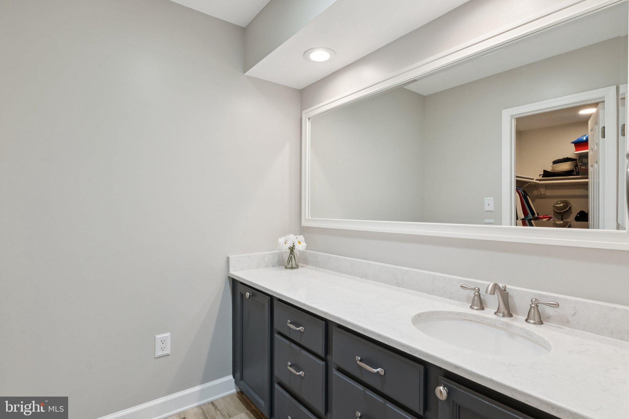 346 Edgewater Road Pasadena, MD 21122 - Photo 28 of 75 a bathroom with a granite countertop sink and a mirror