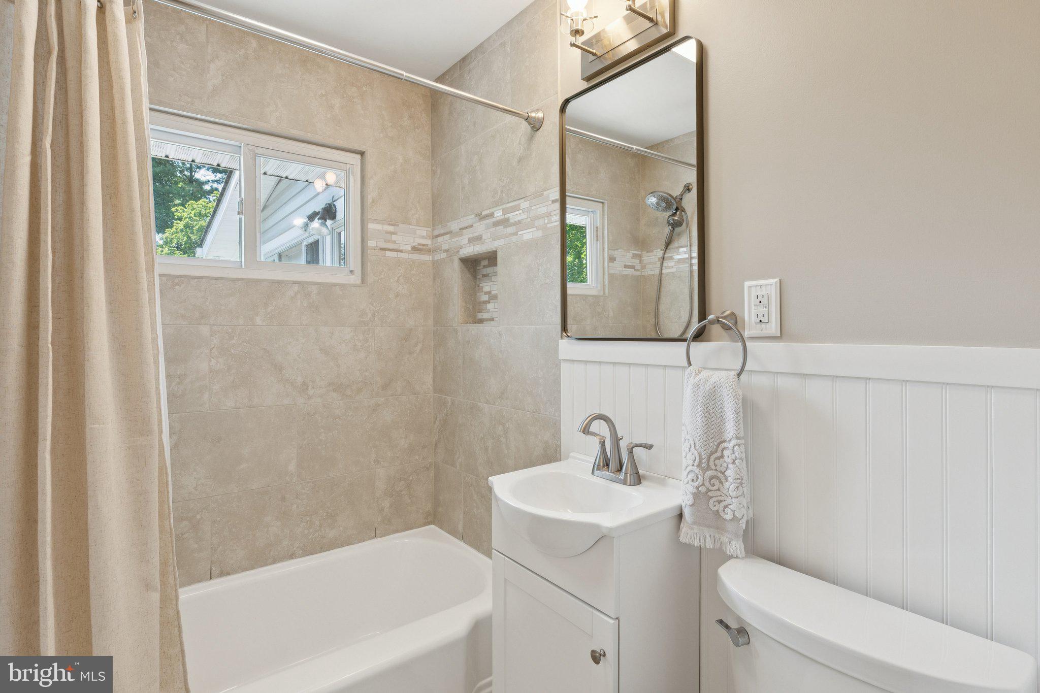 346 Edgewater Road Pasadena, MD 21122 - Photo 37 of 75 a bathroom with a sink a toilet and shower