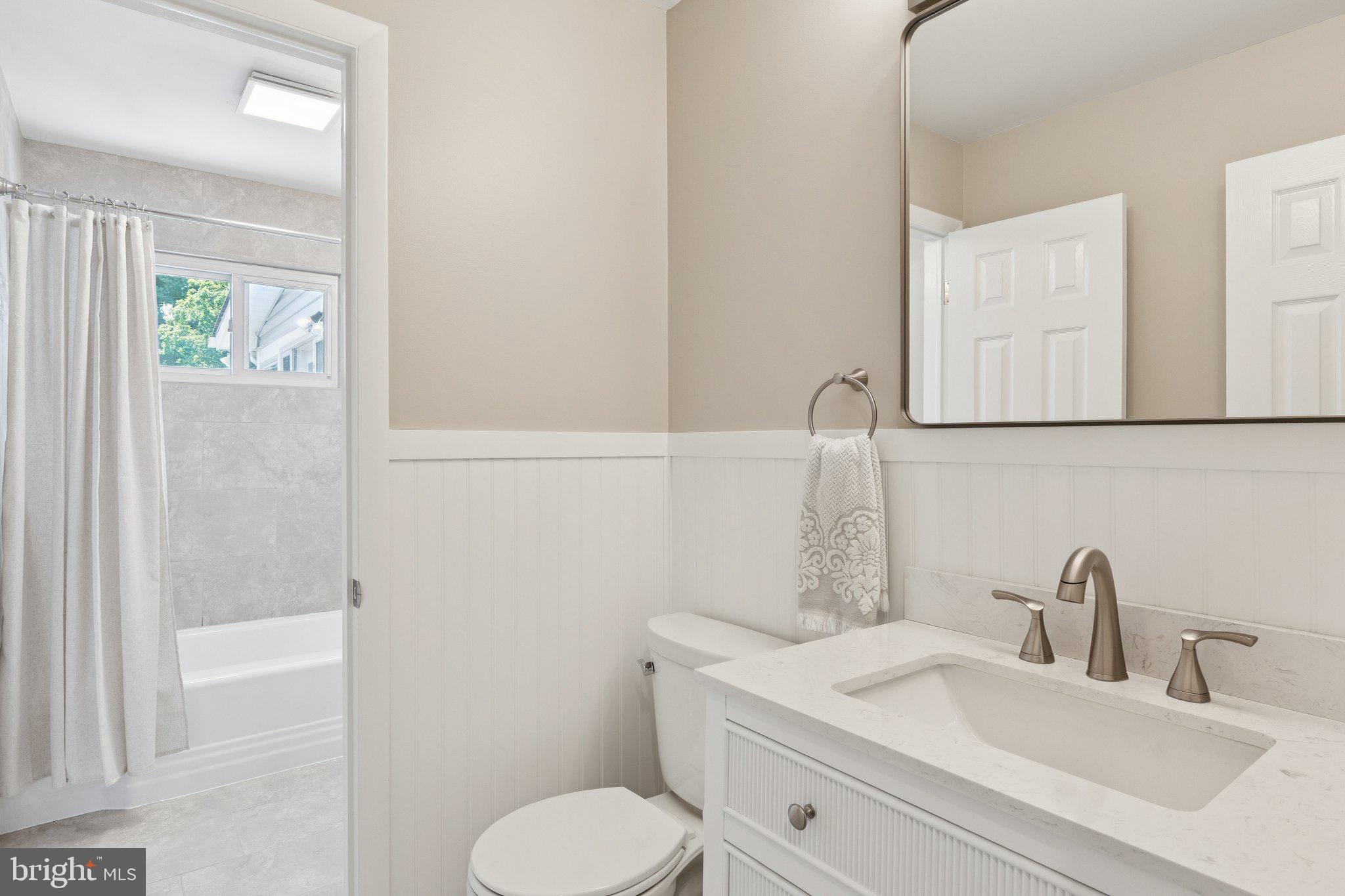 346 Edgewater Road Pasadena, MD 21122 - Photo 38 of 75 a bathroom with a toilet sink and mirror