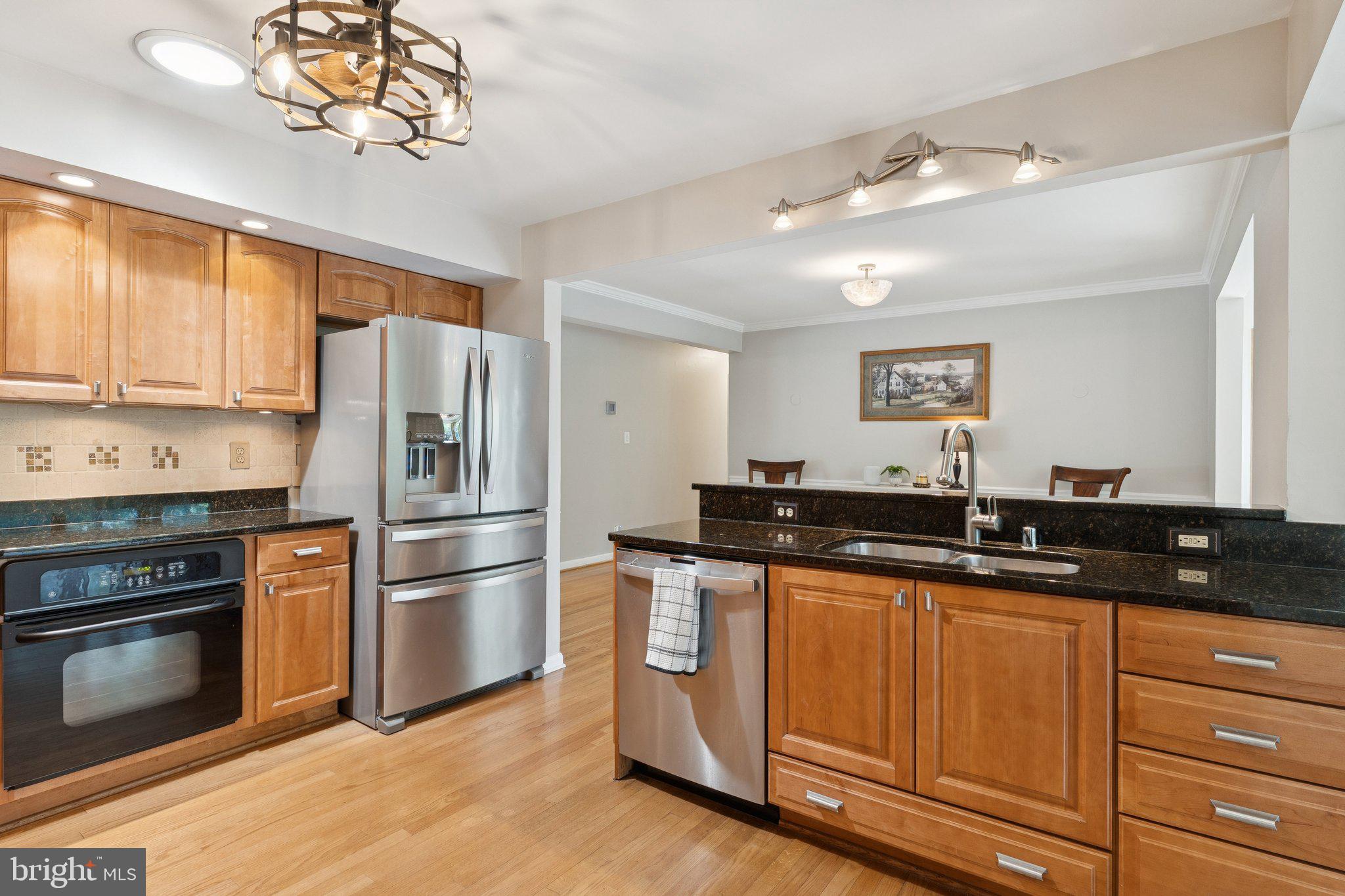 346 Edgewater Road Pasadena, MD 21122 - Photo 6 of 75 a kitchen with granite countertop stainless steel appliances a sink cabinets and a window