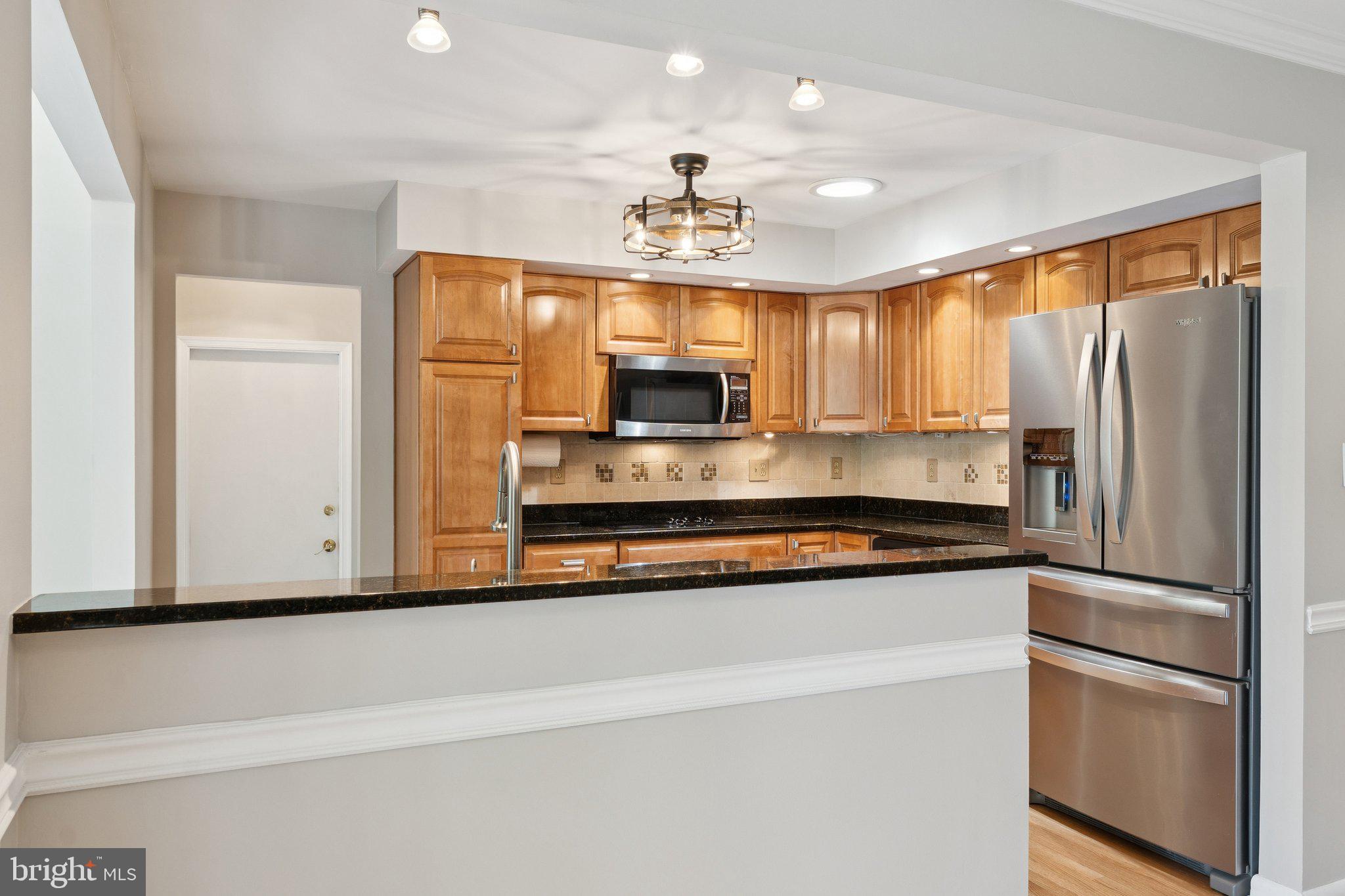 346 Edgewater Road Pasadena, MD 21122 - Photo 7 of 75 a kitchen with stainless steel appliances a refrigerator sink and microwave