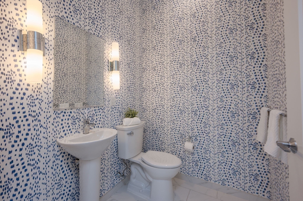 10 Shipyard Drive, Unit 402 Hingham, MA 02043 - Photo 13 of 25 a bathroom with a toilet sink and mirror