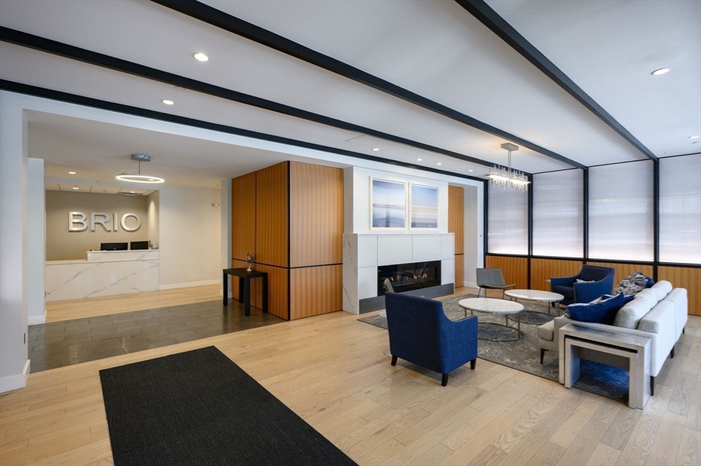 10 Shipyard Drive, Unit 402 Hingham, MA 02043 - Photo 14 of 25 a living room with furniture stove and a table