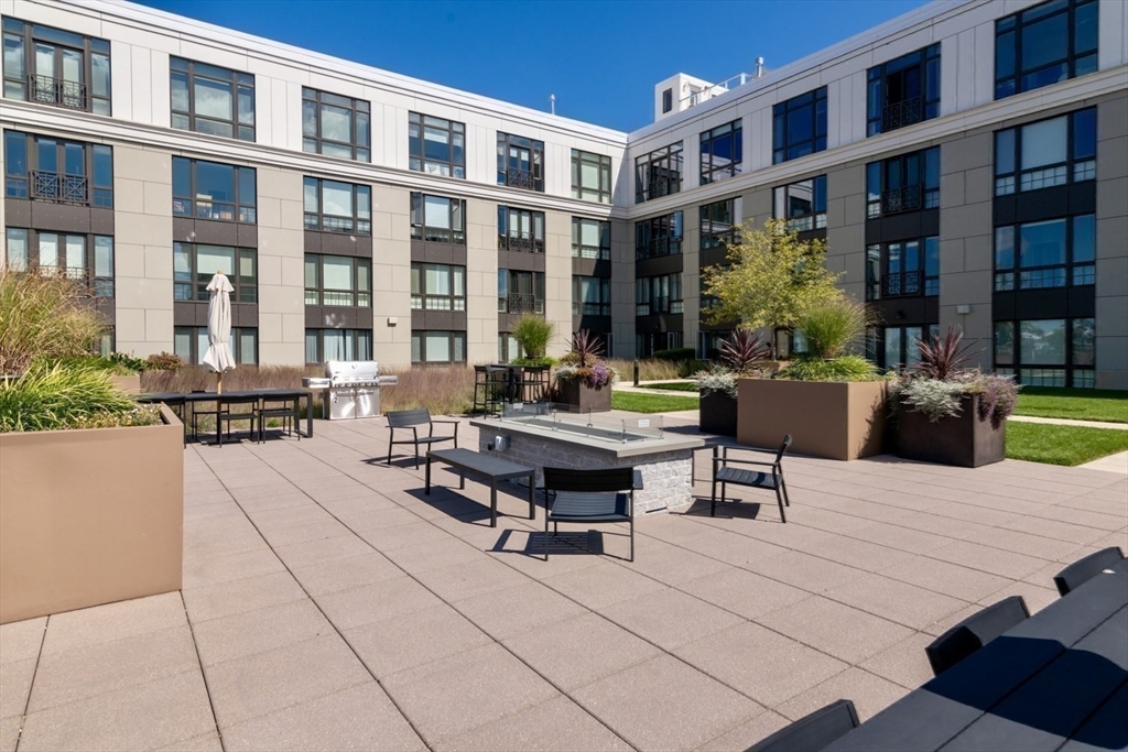 10 Shipyard Drive, Unit 402 Hingham, MA 02043 - Photo 17 of 25 a swimming pool with outdoor seating and plants
