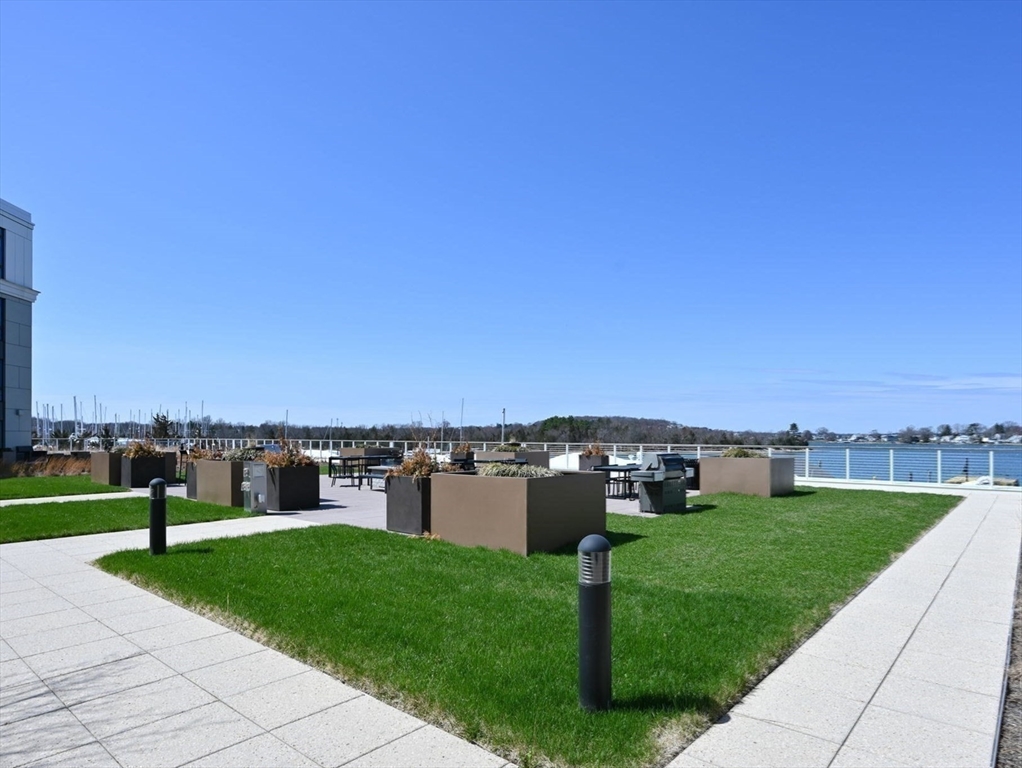 10 Shipyard Drive, Unit 402 Hingham, MA 02043 - Photo 19 of 25 a view of a garden and swimming pool