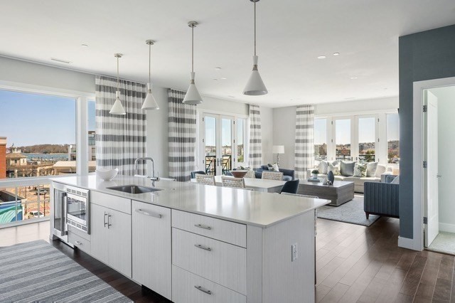 10 Shipyard Drive, Unit 402 Hingham, MA 02043 - Photo 5 of 25 a kitchen with stainless steel appliances granite countertop a stove a sink dishwasher and white cabinets with wooden floor