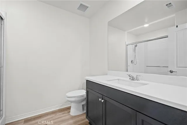 a bathroom with a sink a toilet and mirror