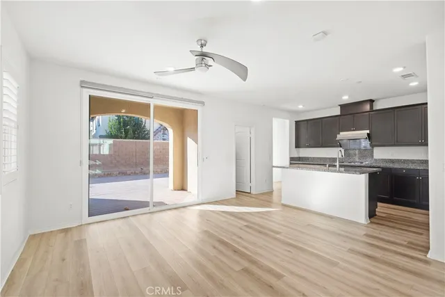 a large kitchen with stainless steel appliances granite countertop a stove and a refrigerator