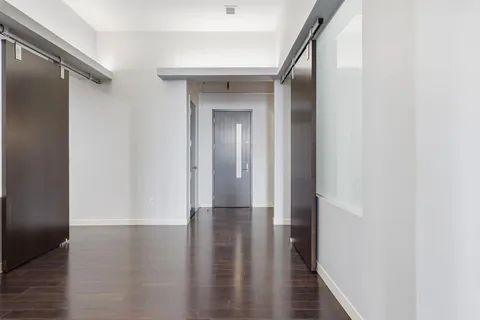 a view of a hallway with wooden floor
