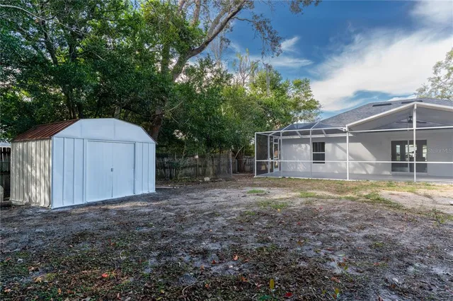 a backyard of a house with table and chairs
