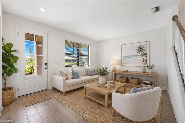 a living room with furniture and a potted plant