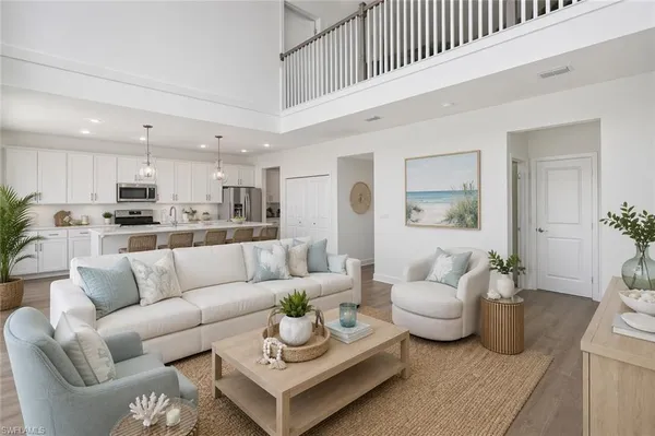 a living room with furniture and view of kitchen