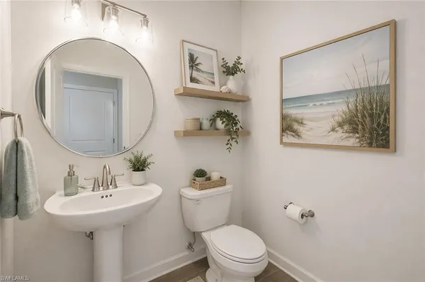 a bathroom with a toilet a sink and mirror