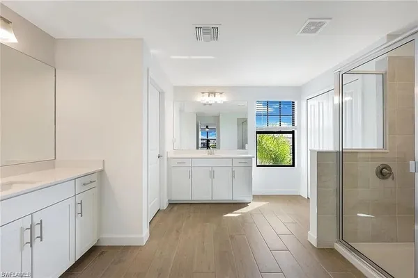 a view of a kitchen with a sink and dishwasher with wooden floor