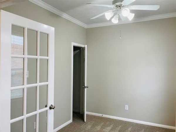 a view of a livingroom with a chandelier fan