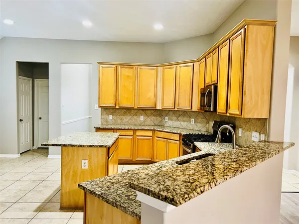 a view of a kitchen with a stove cabinets and wooden floor