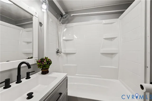 a bathroom with a bathtub and a shower