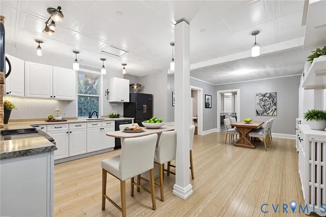 a kitchen with sink cabinets and wooden floor