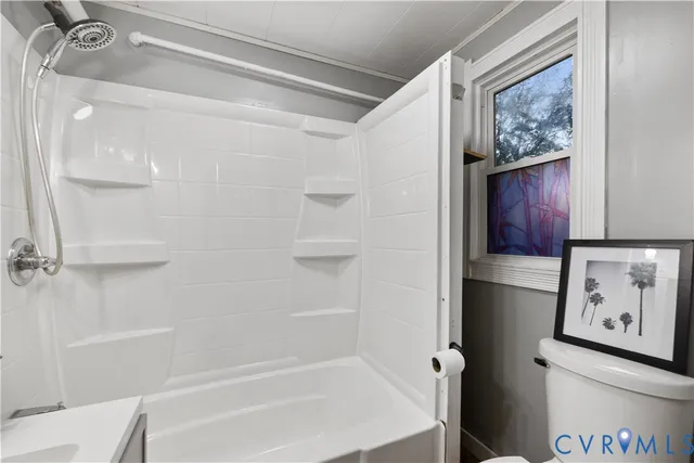 a bathroom with a sink mirror vanity and toilet