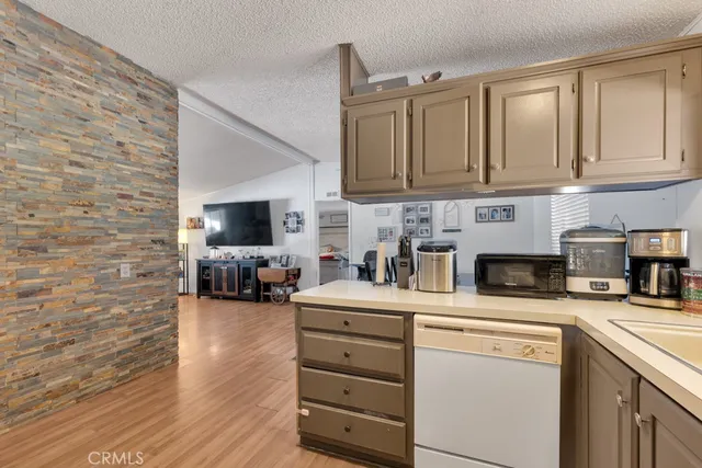 a kitchen with stainless steel appliances a sink a stove and cabinets
