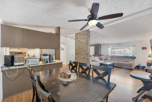 a dining room with furniture a chandelier and wooden floor