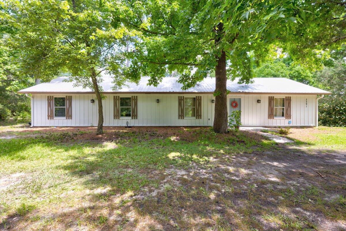 a front view of house with yard and green space