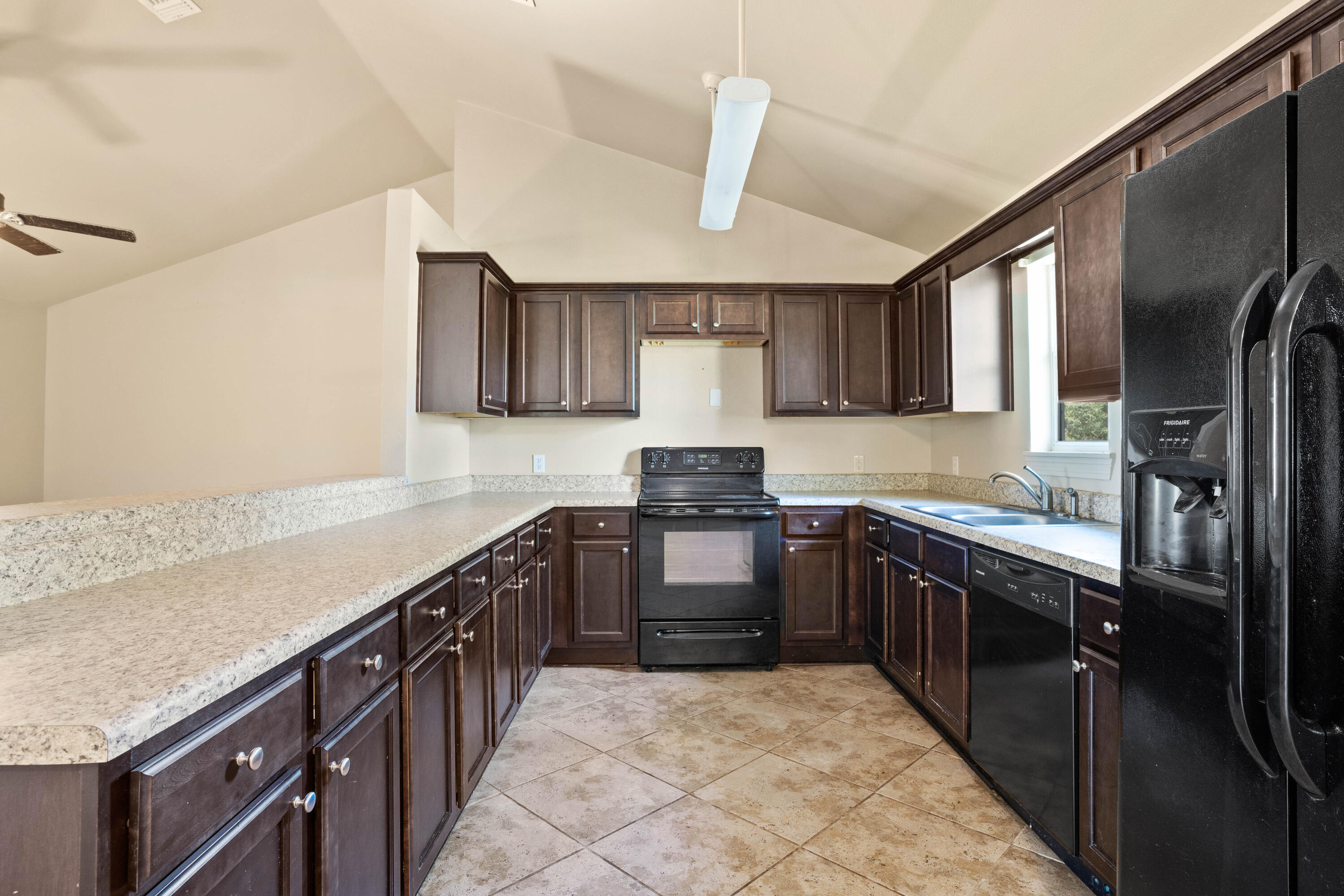 3591 Highway 20 Freeport, FL 32439 - Photo 11 of 23 a kitchen with stainless steel appliances granite countertop a sink stove refrigerator and cabinets