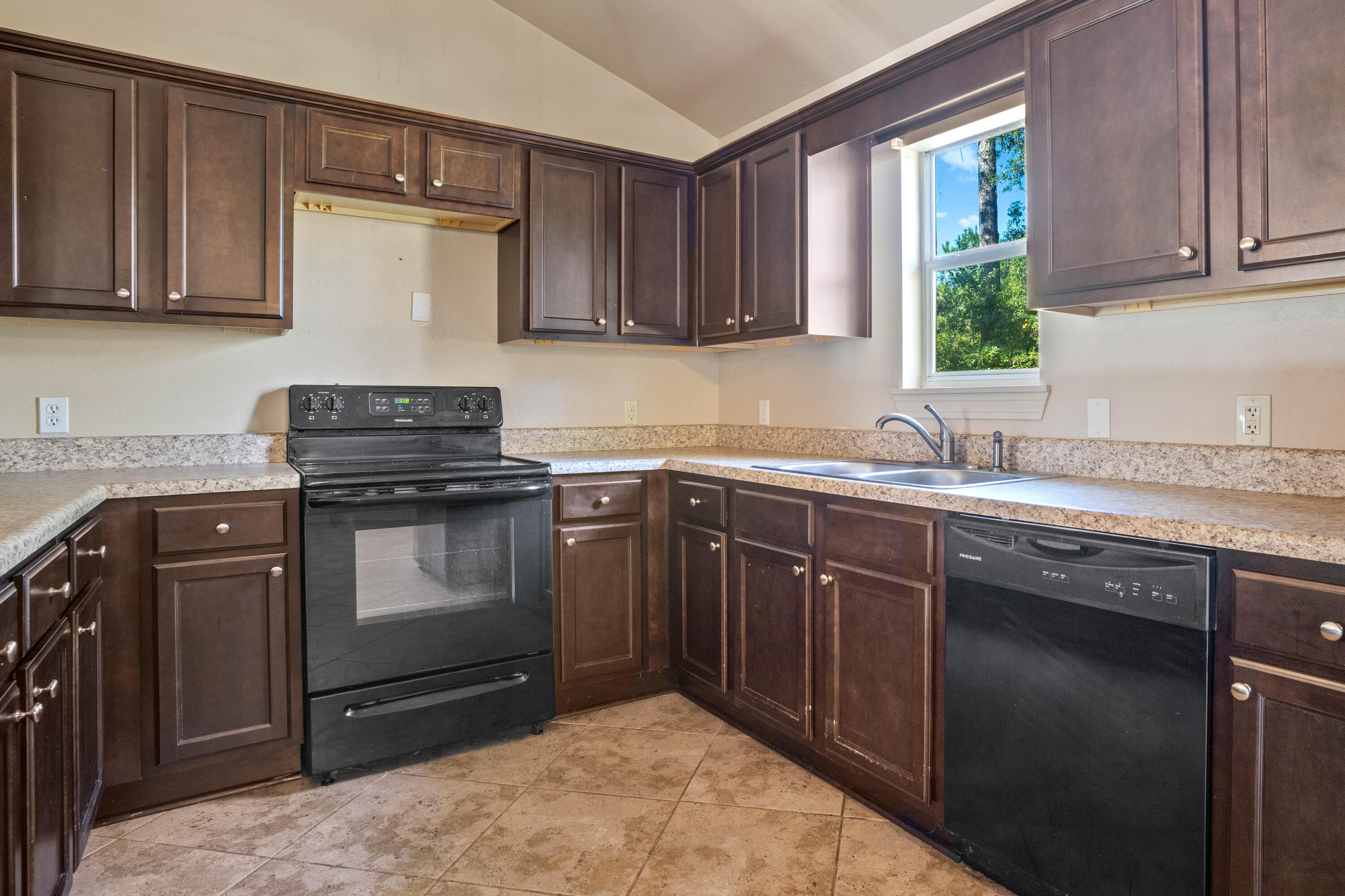 3591 Highway 20 Freeport, FL 32439 - Photo 12 of 23 a kitchen with a sink stove and cabinets