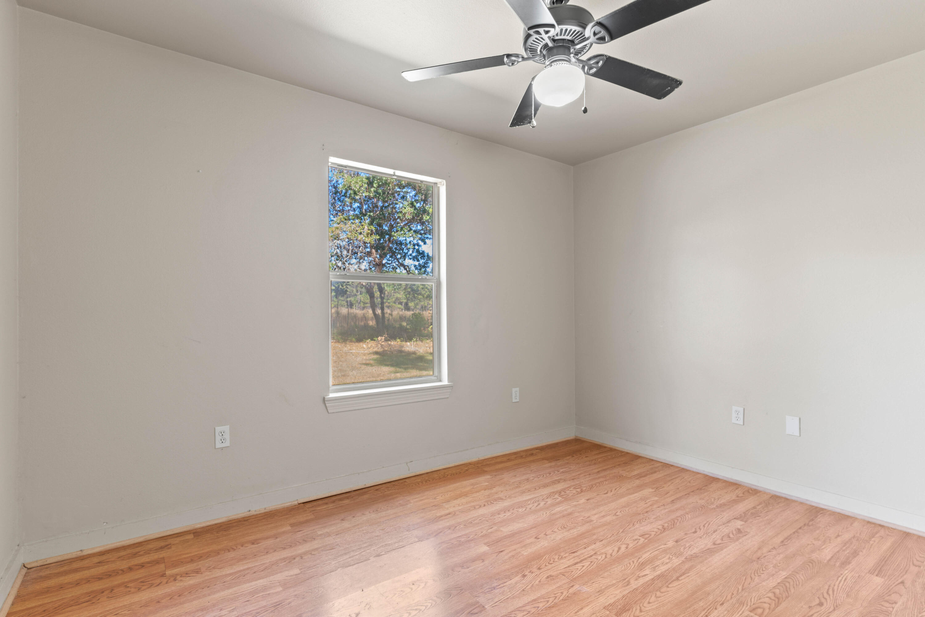 3591 Highway 20 Freeport, FL 32439 - Photo 21 of 23 an empty room with a window and a fan