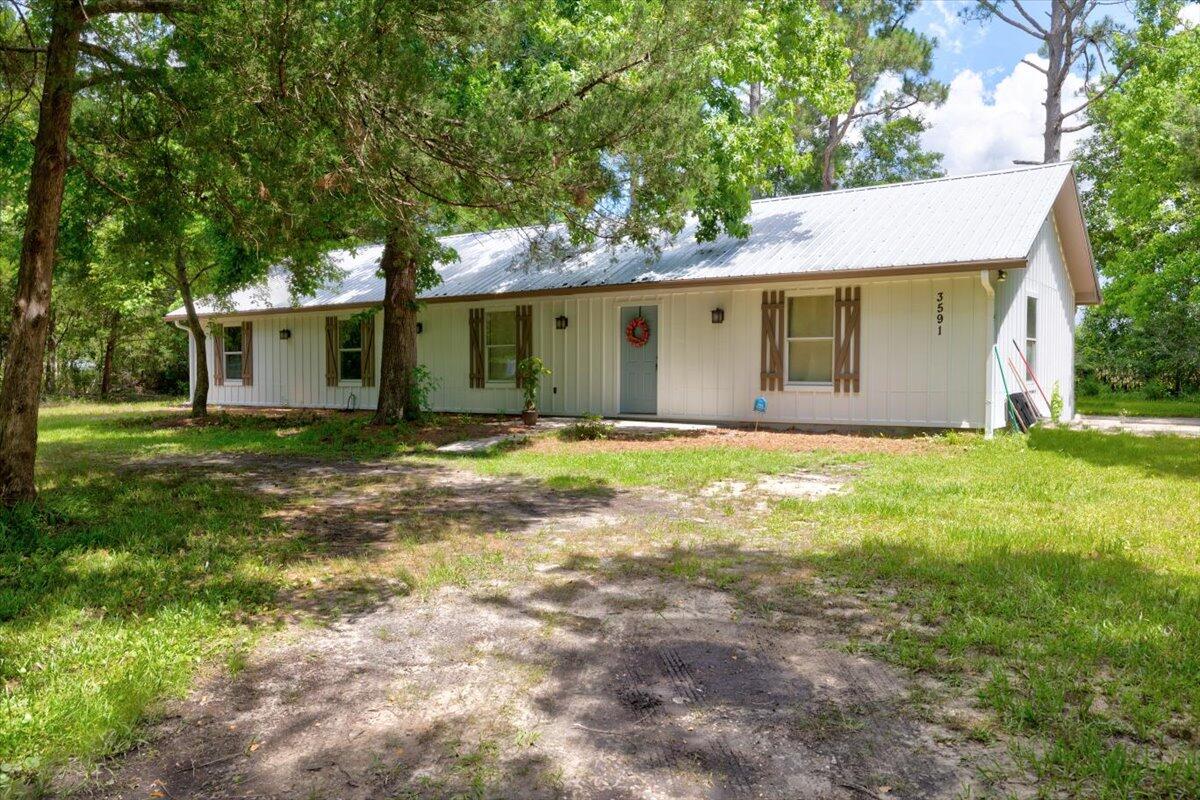 3591 Highway 20 Freeport, FL 32439 - Photo 4 of 23 a view of a house with yard and tree s