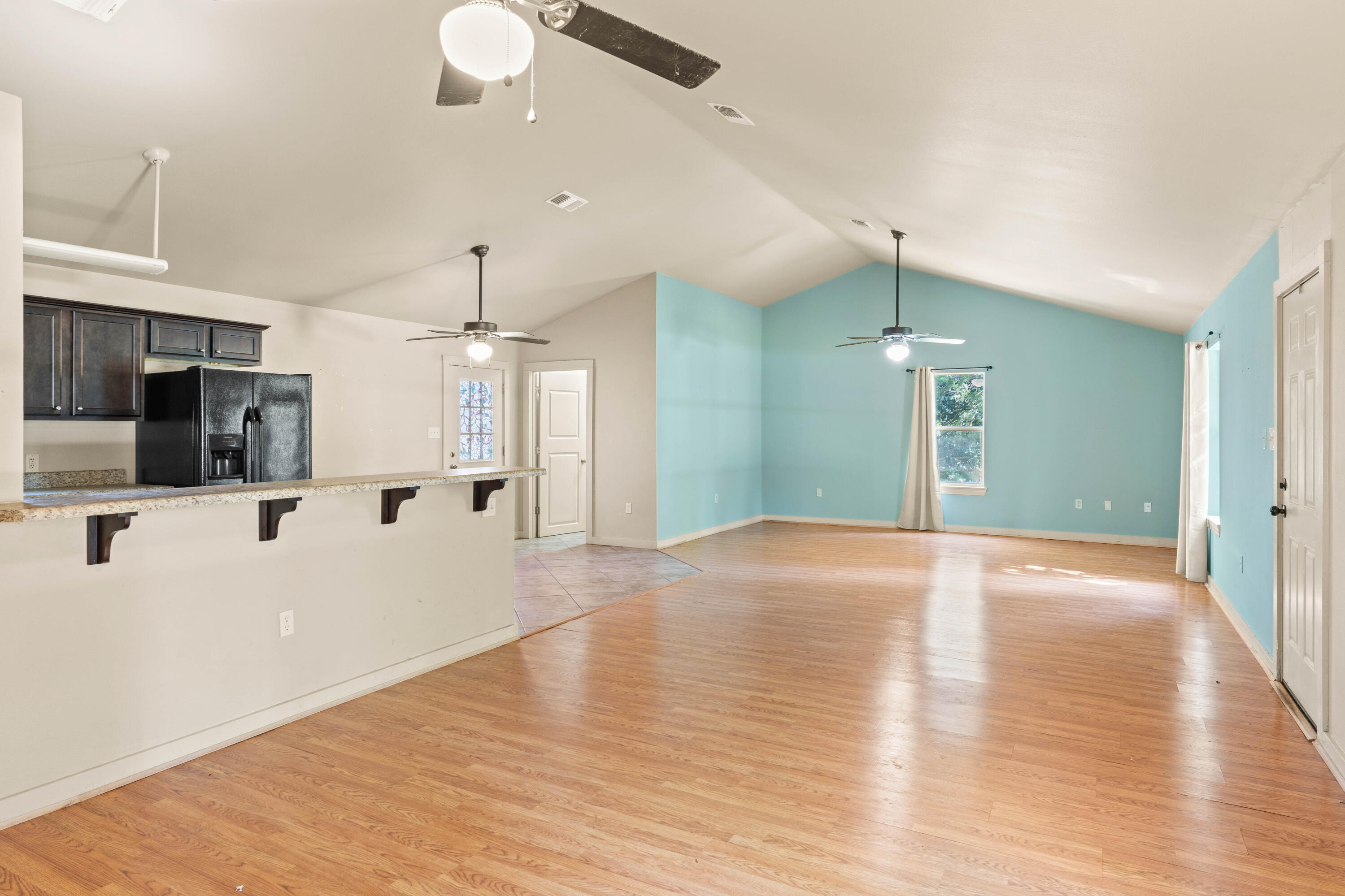 3591 Highway 20 Freeport, FL 32439 - Photo 7 of 23 a view of a kitchen with a sink and a refrigerator