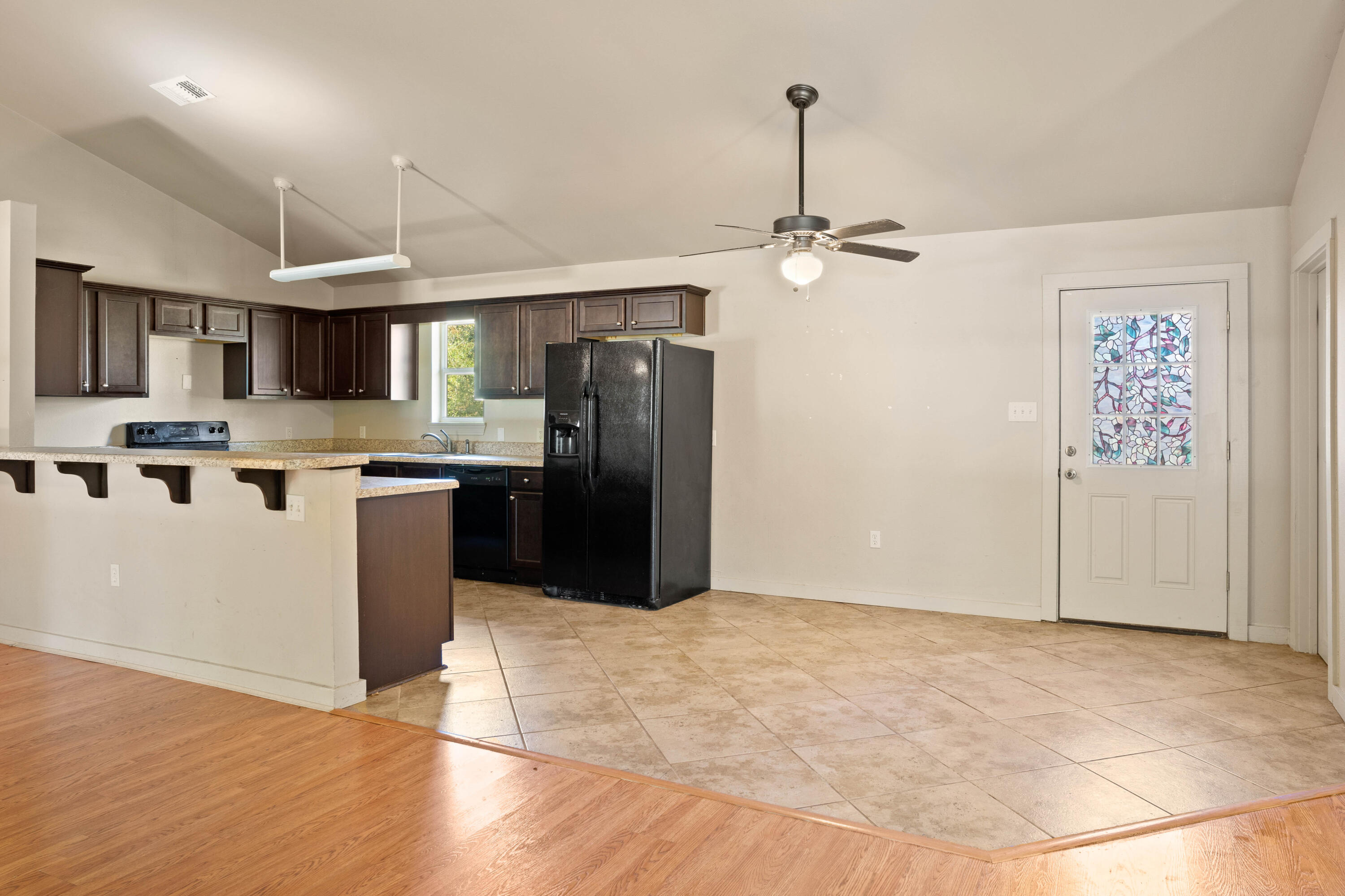 3591 Highway 20 Freeport, FL 32439 - Photo 9 of 23 a kitchen with stainless steel appliances granite countertop a refrigerator a stove top oven a sink and dishwasher