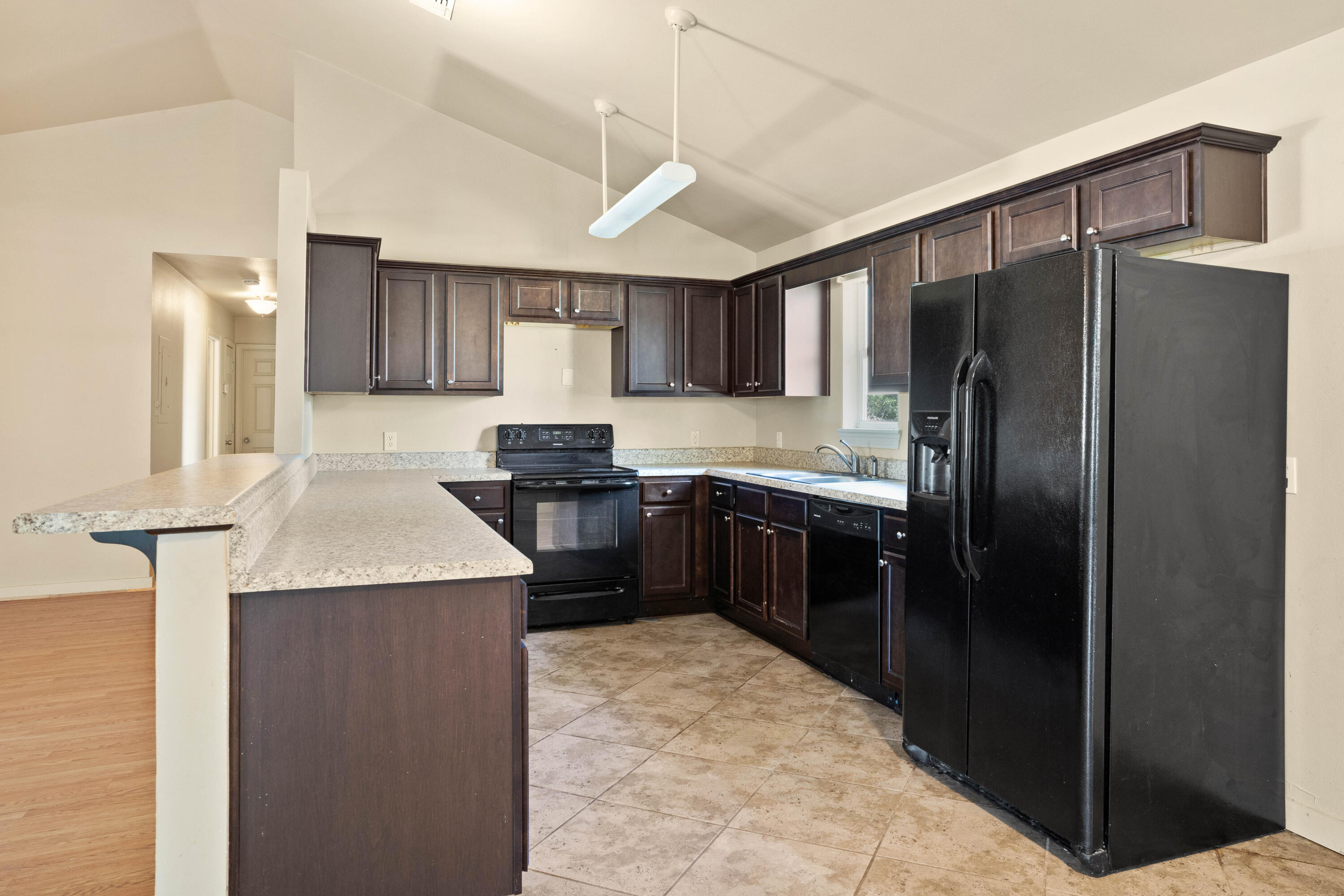 3591 Highway 20 Freeport, FL 32439 - Photo 10 of 23 a kitchen with stainless steel appliances granite countertop a refrigerator a sink a stove a microwave and wooden cabinets