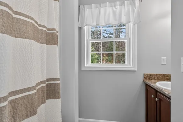 a bathroom with a sink and a window