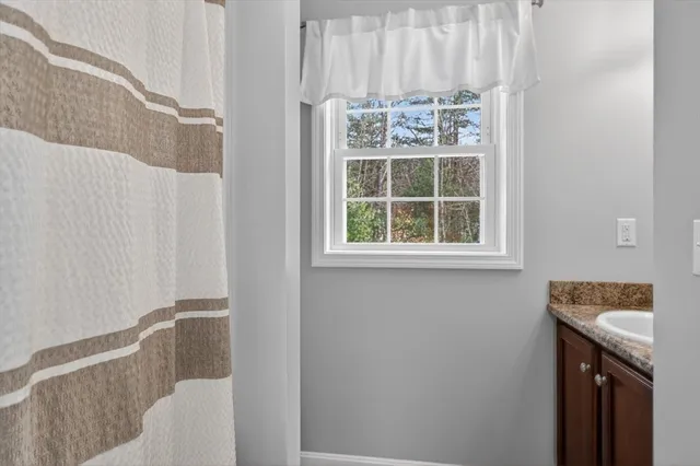 a bathroom with a sink and a window