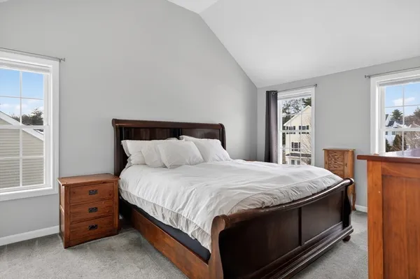 a bed sitting in a bedroom chandelier and dresser