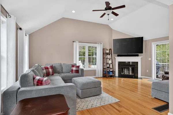 a living room with fireplace furniture and a flat screen tv
