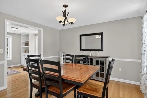a view of a dining room with furniture and wooden floor