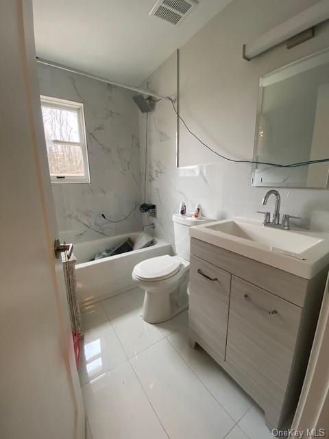 a bathroom with a double vanity sink mirror and toilet