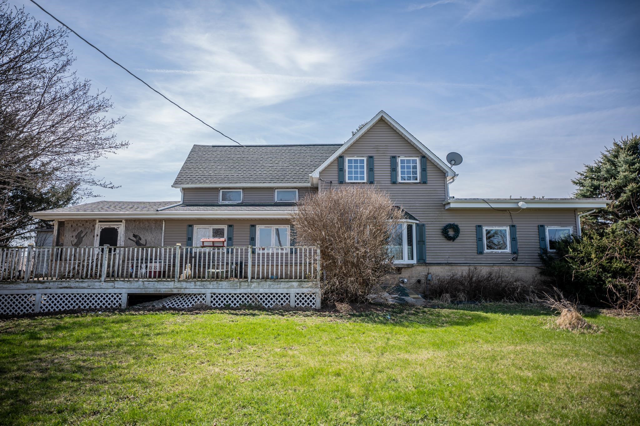 a front view of house with yard and trees
