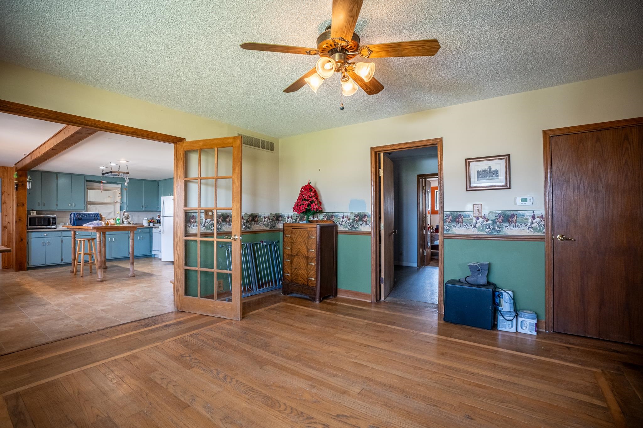 13965 East Dutch Road Rochelle, IL 61068 - Photo 12 of 50 a view of a livingroom with a furniture wooden floor and a ceiling fan