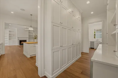a view of a room with a large window and wooden floor