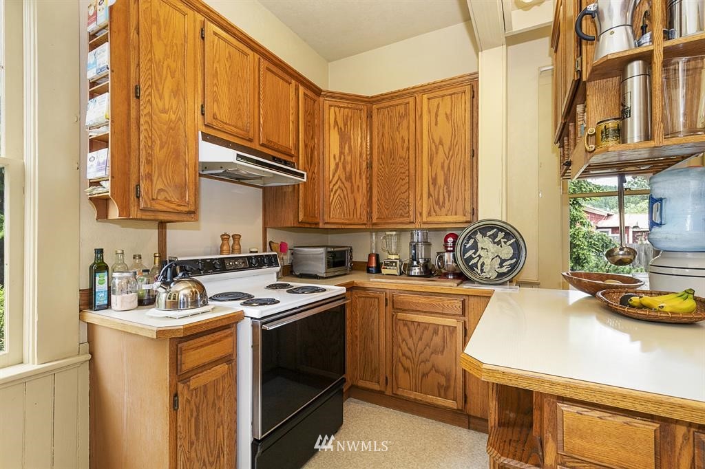 31 Center Road Chimacum, WA 98325 - Photo 3 of 35 a utility room with stainless steel appliances granite countertop a sink a stove and a refrigerator