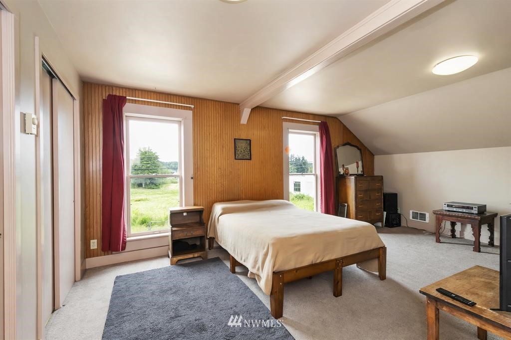 31 Center Road Chimacum, WA 98325 - Photo 23 of 35 a bedroom with a bed and large windows