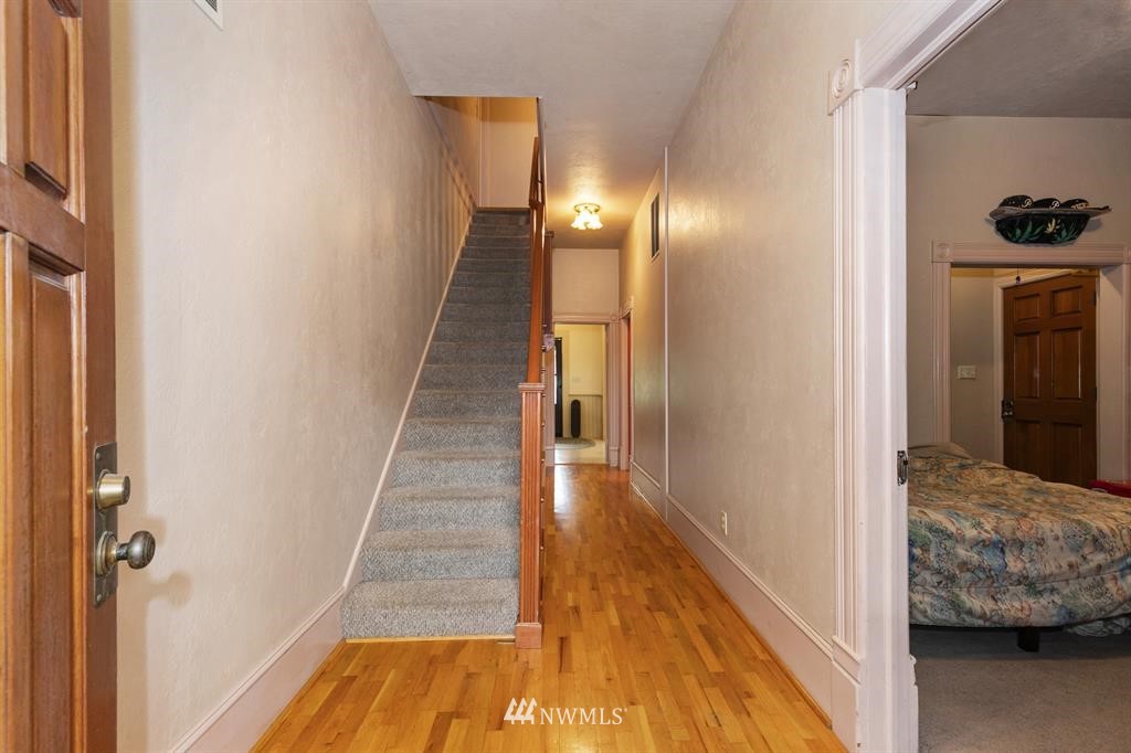 31 Center Road Chimacum, WA 98325 - Photo 8 of 35 a view of a hallway with wooden floor and staircase