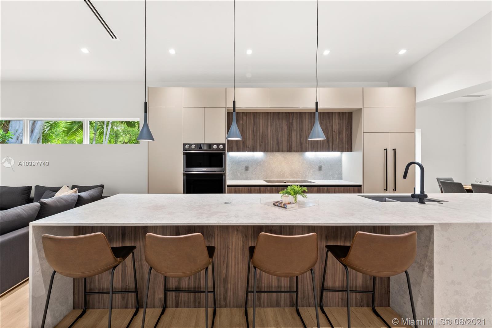 270 Southwest 29th Road Miami, FL 33129 - Photo 8 of 48 a kitchen with a table chairs sink and cabinets