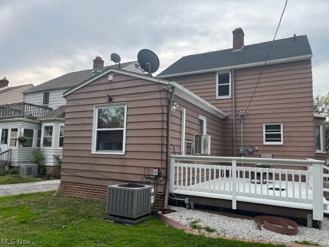 1227 Winston Road Cleveland, OH 44121 - Photo 12 of 15 Rear view of house with a wooden deck and central AC unit