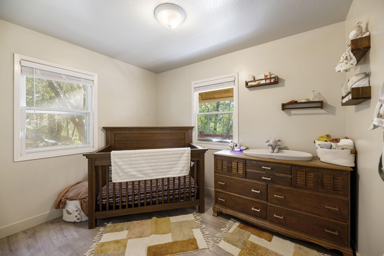 6324 East Evans Creek Road Rogue River, OR 97537 - Photo 17 of 31 a bed room with a bed and a window