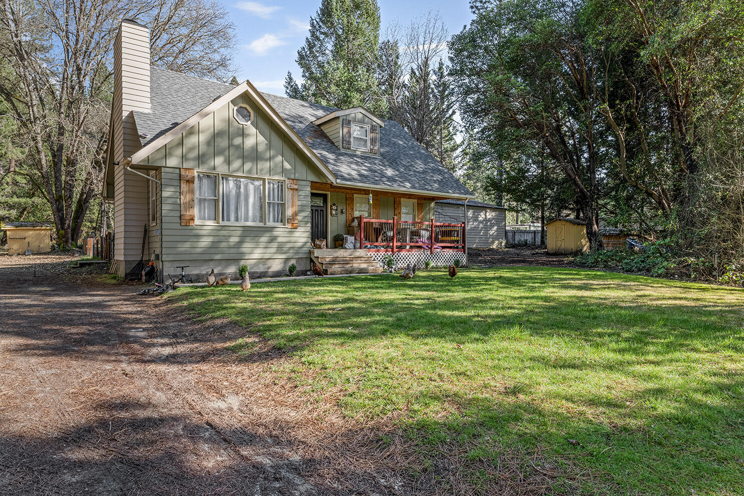 6324 East Evans Creek Road Rogue River, OR 97537 - Photo 6 of 31 a view of a house next to a big yard and large trees