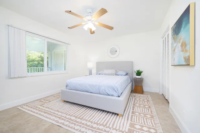 a bedroom with a large bed and a window